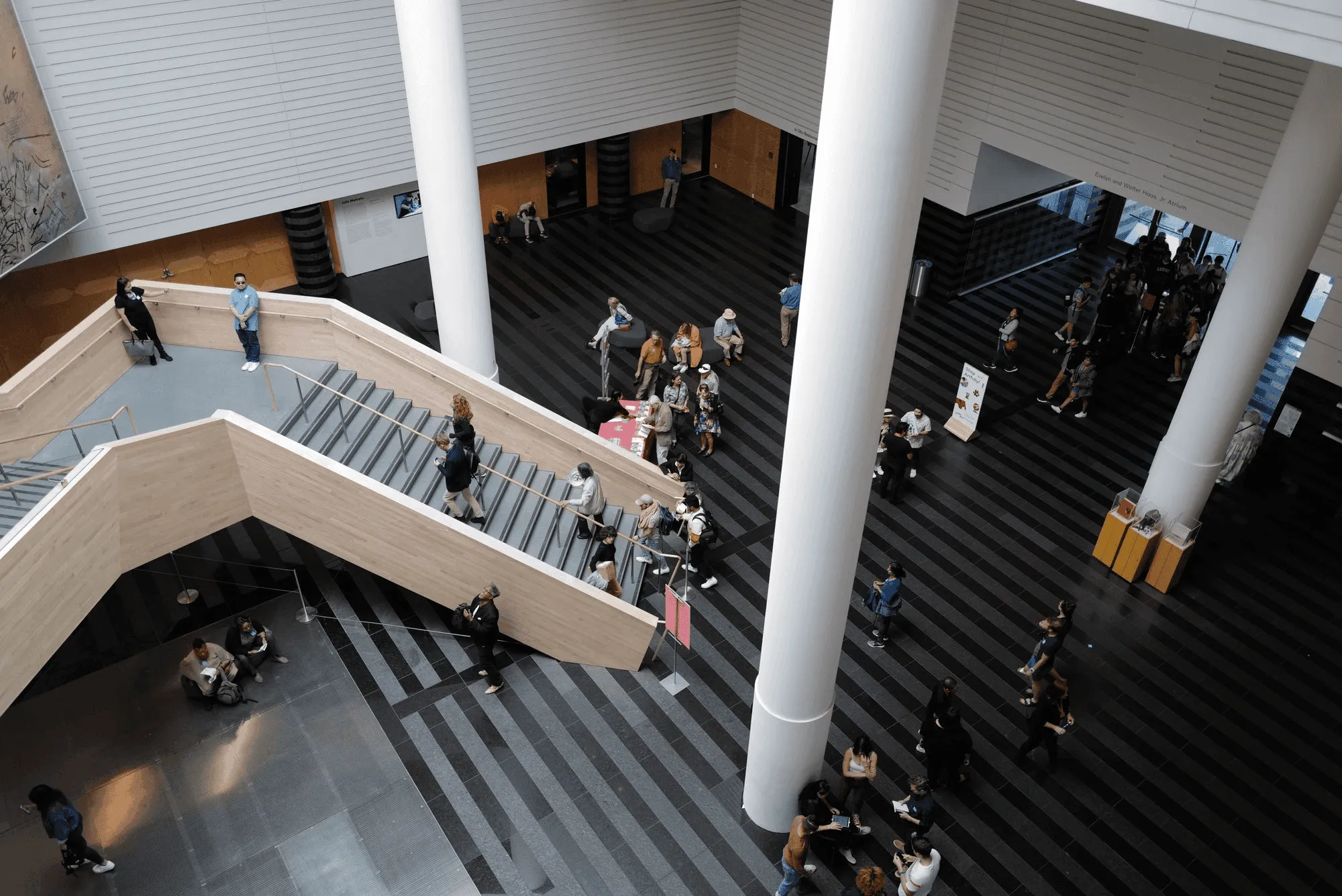 Visitors moving through the Museum of Modern Art's atrium on a busy afternoon